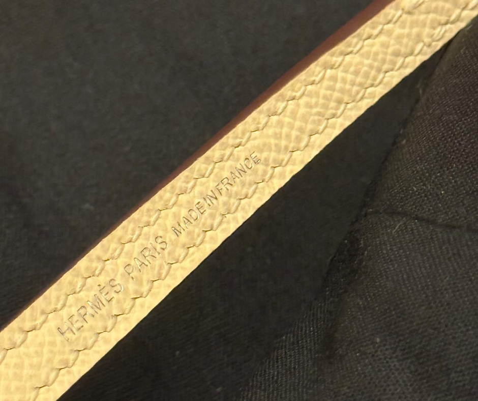 Hermès snap closure detail on Jaune leather strap